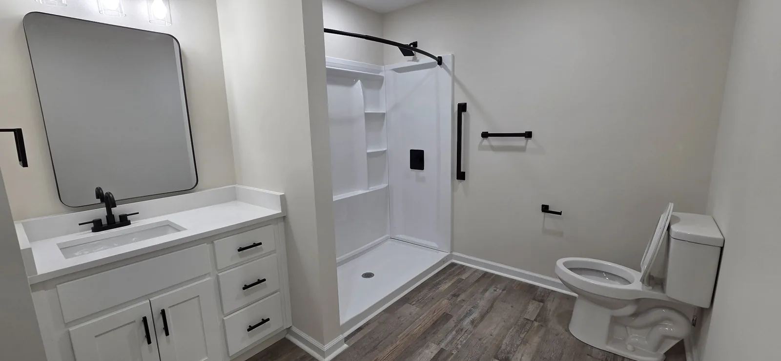 An accessible Marlboro bathroom with a wide vanity, step-in shower and grab bar.
