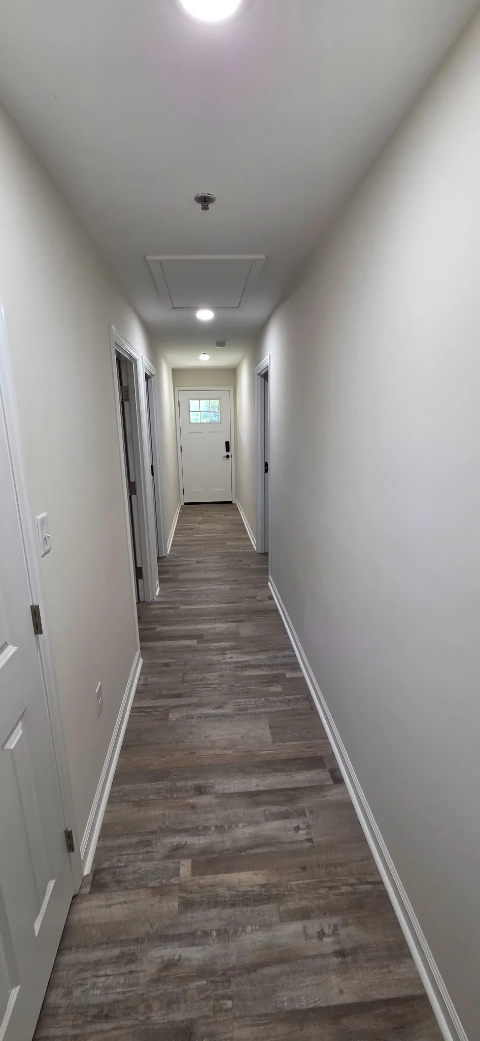 The interior corridor at Marlboro, brightly lit with apartment doors on both sides.