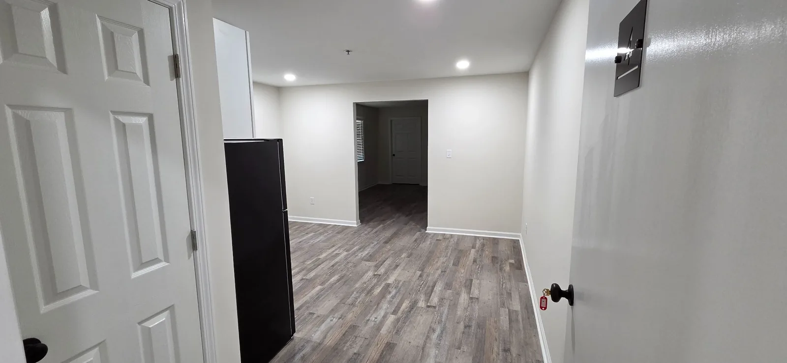 Looking into a Marlboro apartment from the entry door, past the refrigerator into the living space.