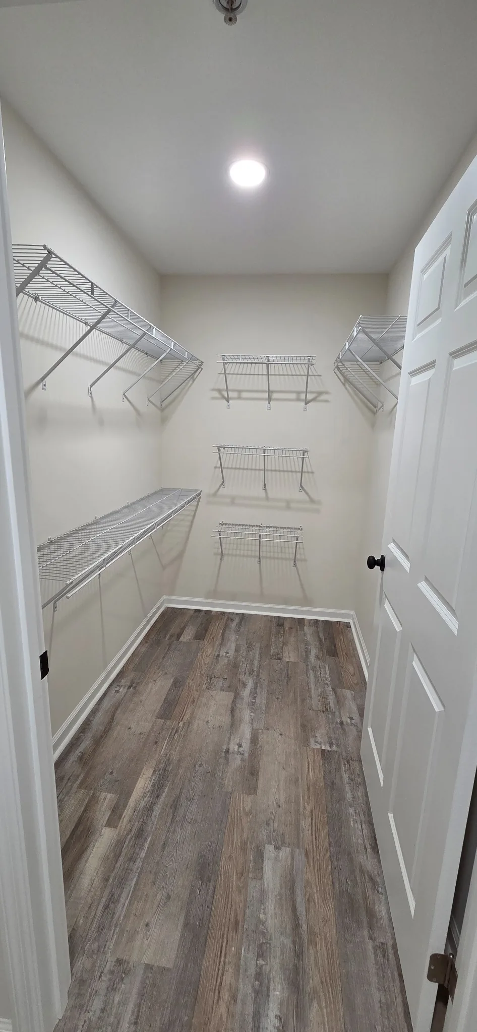 A Marlboro walk-in closet fitted with wire shelving and a hanging rail.