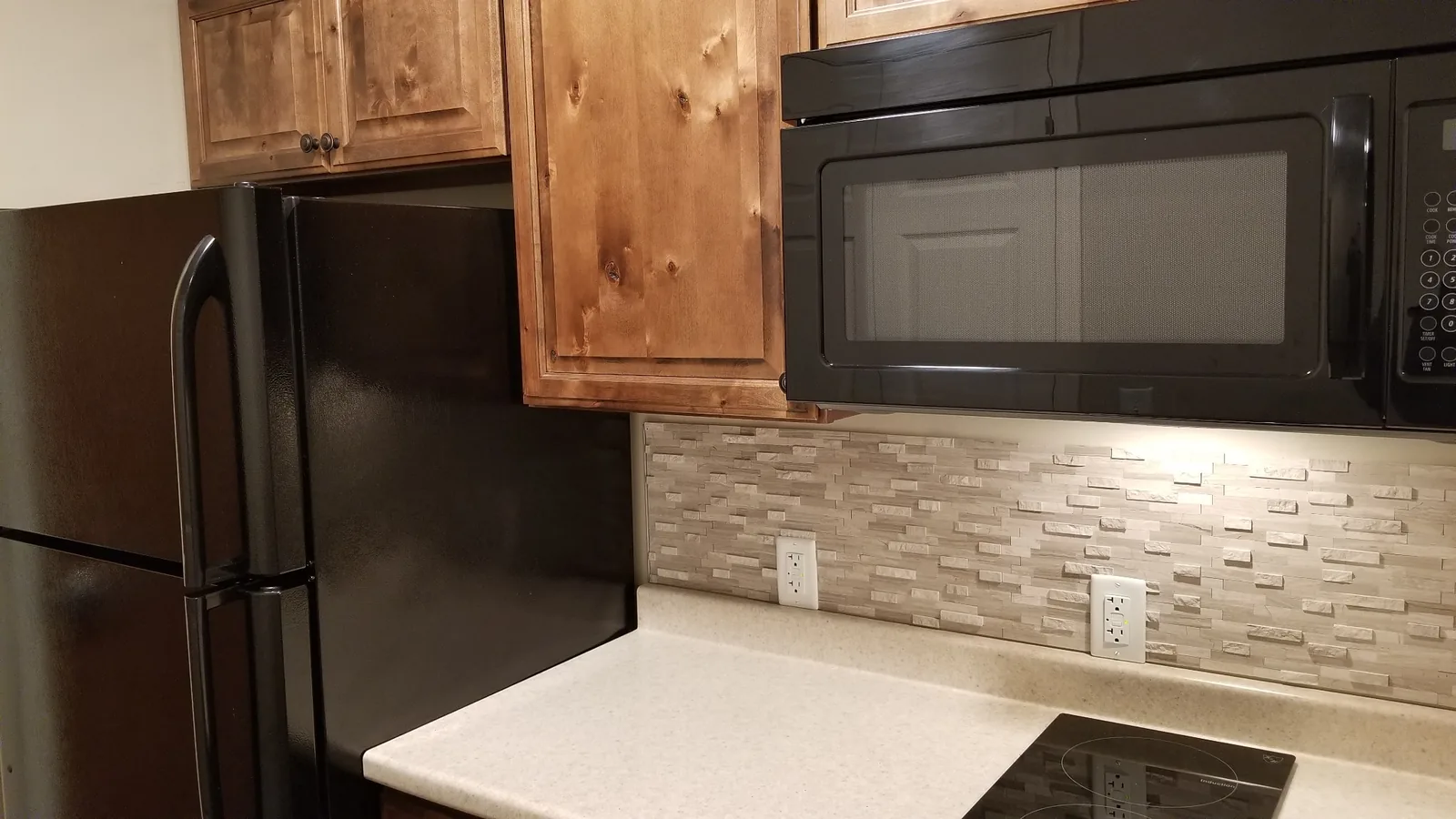 Refrigerator and over-range microwave in a Silverdale kitchen.