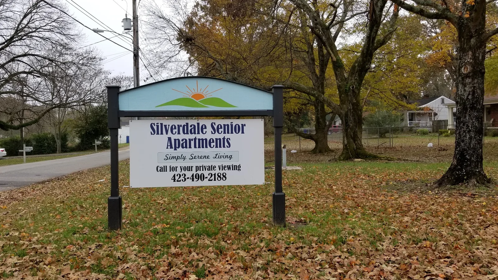 The Silverdale Senior Apartments roadside sign with the sunrise-and-hills logo.